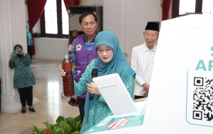 Ketua TP PKK Jateng Nawal Arafah Yasin memegang botol minyak bekas dalam peluncuran program jual minyak jelantah di Semarang.