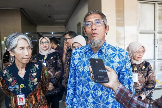 Sekda Provinsi Jawa Tengah Sumarno mengenakan kemeja batik biru sedang memberikan keterangan pers kepada wartawan terkait kebijakan flexi time ASN pada Hari Pertama Sekolah.