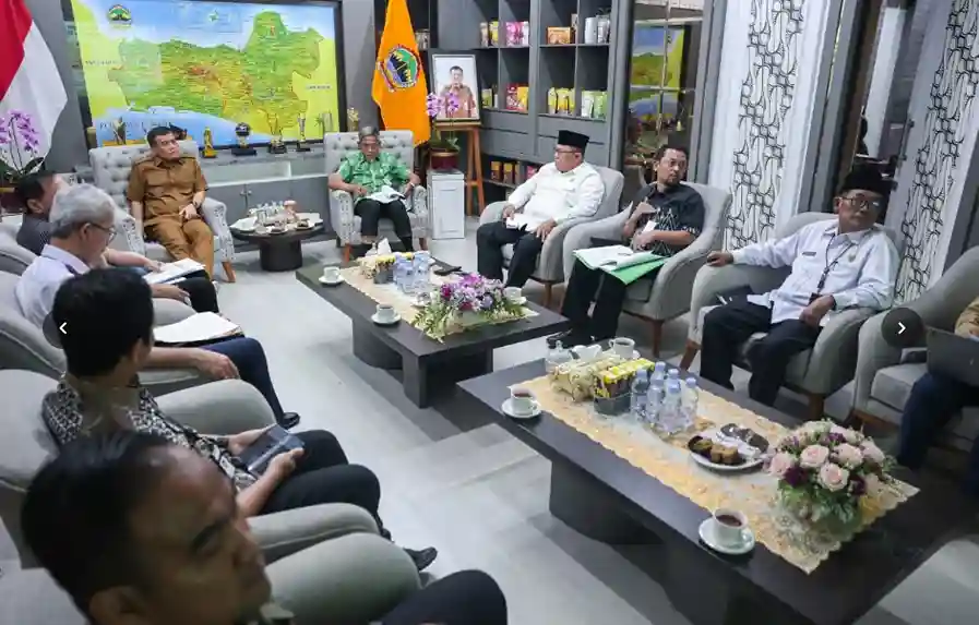 Suasana rapat formal di Pemerintah Provinsi Jawa Tengah, Semarang, menunjukkan sekelompok pejabat duduk melingkar di sofa membahas dokumen persiapan MTQ Nasional ke-31, dengan latar belakang peta besar Jawa Tengah.